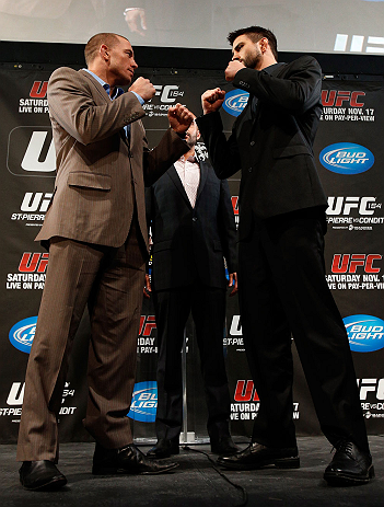 MONTREAL, CANADA - NOVEMBER 14:  (L-R) Opponents Georges St-Pierre and Carlos Condit face off during the final pre-fight press conference ahead of UFC 154 at New City Gas on November 14, 2012 in Montreal, Quebec, Canada.  (Photo by Josh Hedges/Zuffa LLC/Zuffa LLC via Getty Images)