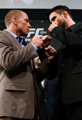 MONTREAL, CANADA - NOVEMBER 14:  (L-R) Opponents Georges St-Pierre and Carlos Condit face off during the final pre-fight press conference ahead of UFC 154 at New City Gas on November 14, 2012 in Montreal, Quebec, Canada.  (Photo by Josh Hedges/Zuffa LLC/Zuffa LLC via Getty Images)