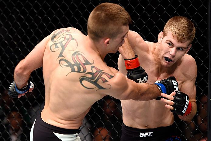 LAS VEGAS, NV - JULY 08: (R-L) Jake Matthews of Australia punches Kevin Lee in their lightweight bout during The Ultimate Fighter Finale event at MGM Grand Garden Arena on July 8, 2016 in Las Vegas, Nevada. (Photo by Jeff Bottari/Zuffa LLC)