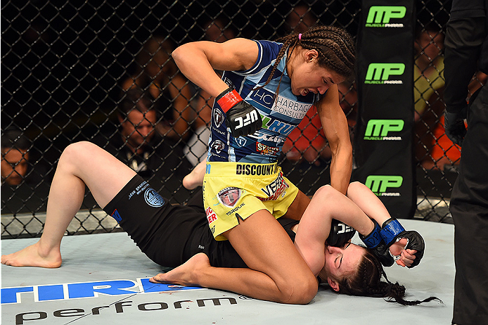 FAIRFAX, VA - APRIL 04: (L-R) Juliana Pena punches Milana Dudieva on the ground in their women's bantamweight fight during the UFC Fight Night event at the Patriot Center on April 4, 2015 in Fairfax, Virginia. (Photo by Josh Hedges/Zuffa LLC/Zuffa LLC via Getty Images)