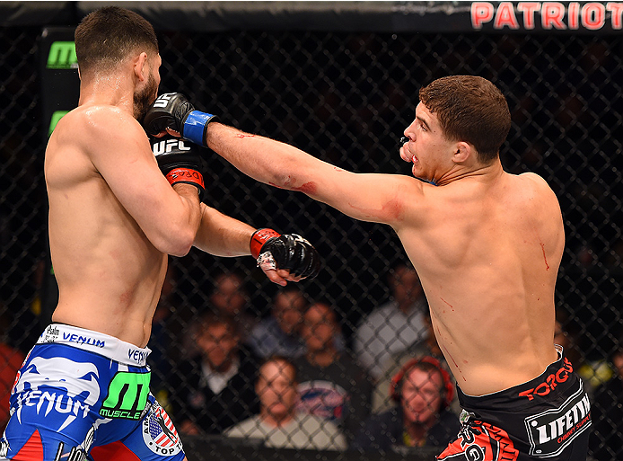 FAIRFAX, VA - APRIL 04: (R-L) Al Iaquinta punches Jorge Masvidal in their lightweight fight during the UFC Fight Night event at the Patriot Center on April 4, 2015 in Fairfax, Virginia. (Photo by Josh Hedges/Zuffa LLC/Zuffa LLC via Getty Images)