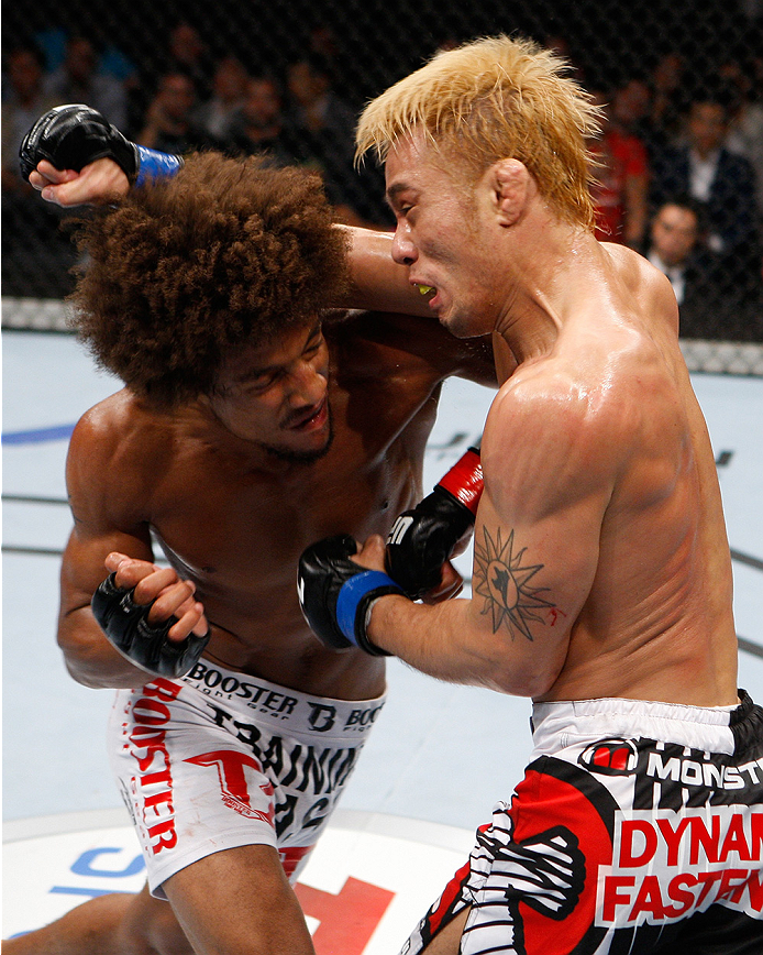 SAITAMA, JAPAN - SEPTEMBER 20:  Alex Caceres and Masanori Kanehara exchange a fury of punches in their bantamweight bout during the UFC Fight Night event inside the Saitama Arena on September 20, 2014 in Saitama, Japan. (Photo by Mitch Viquez/Zuffa LLC/Zuffa LLC via Getty Images)