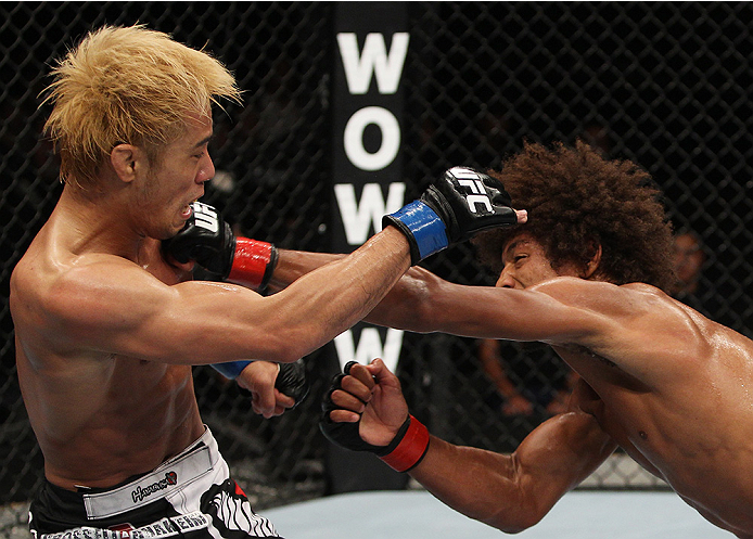 SAITAMA, JAPAN - SEPTEMBER 20: Alex Caceres throws a punch at Masanori Kanehara in their bantamweight bout during the UFC Fight Night event inside the Saitama Arena on September 20, 2014 in Saitama, Japan. (Photo by Mitch Viquez/Zuffa LLC/Zuffa LLC via Getty Images)