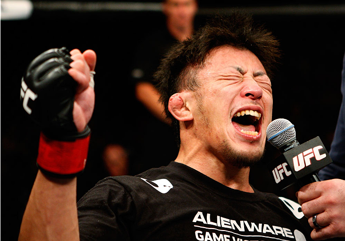 SINGAPORE - JANUARY 04:  Tatsuya Kawajiri celebrates his win over Sean Soriano in their featherweight bout during the UFC Fight Night event at the Marina Bay Sands Resort on January 4, 2014 in Singapore. (Photo by Mitch Viquez/Zuffa LLC/Zuffa LLC via Getty Images)