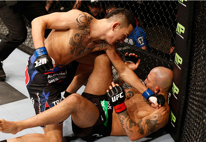 Hollaway (left) finishes Corassani