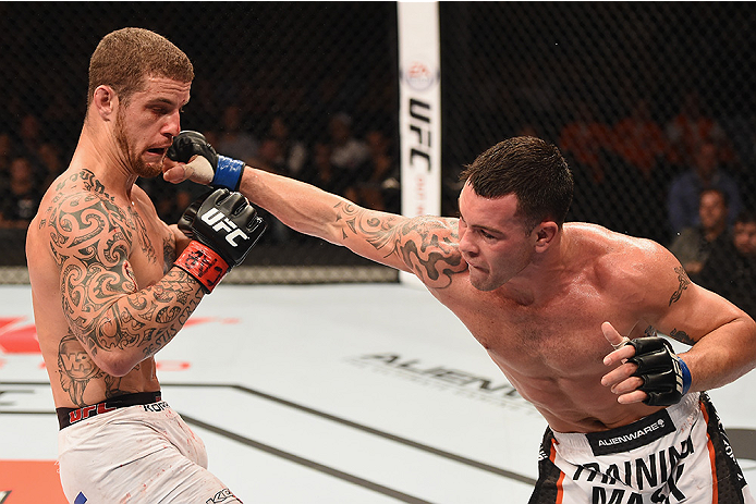Covington (right) punches Silva