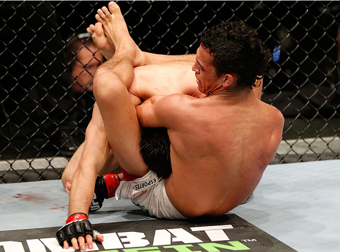 AUCKLAND, NEW ZEALAND - JUNE 28:  (R-L) Charles Oliveira secures a guillotine choke submission against Hatsu Hioki in their featherweight fight during the UFC Fight Night event at Vector Arena on June 28, 2014 in Auckland, New Zealand.  (Photo by Josh Hedges/Zuffa LLC/Zuffa LLC via Getty Images)