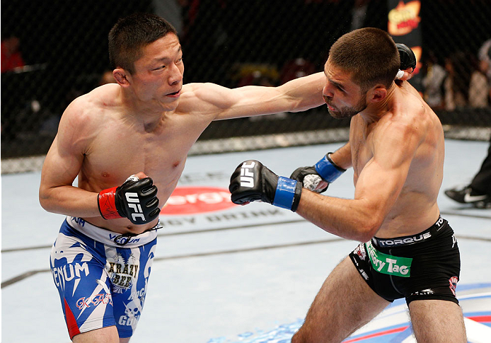 CINCINNATI, OH - MAY 10:  (L-R) Kyoji Horiguchi punches Darrell Montague in their flyweight fight during the UFC Fight Night event at the U.S. Bank Arena on May 10, 2014 in Cincinnati, Ohio. (Photo by Josh Hedges/Zuffa LLC/Zuffa LLC via Getty Images)