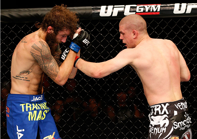 Joe Lauzon punches Michael Chiesa in their lightweight bout during the UFC Fight Night event at Foxwoods Resort Casino on September 5, 2014 in Mashantucket, CT. (Photo by Josh Hedges/Zuffa LLC)