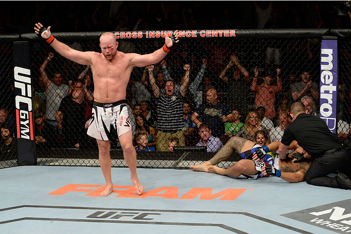 BANGOR, ME - AUGUST 16:  (L-R) Tim Boetsch celebrates after knocking out Brad Tavares in their middleweight bout during the UFC fight night event at the Cross Insurance Center on August 16, 2014 in Bangor, Maine. (Photo by Jeff Bottari/Zuffa LLC/Zuffa LLC via Getty Images)