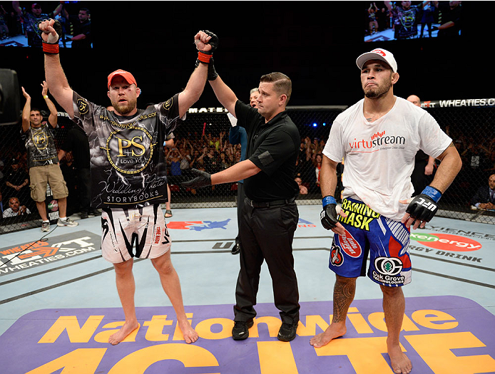 BANGOR, ME - AUGUST 16:  (L-R) Tim Boetsch celebrates after defeating Brad Tavares in their middleweight bout during the UFC fight night event at the Cross Insurance Center on August 16, 2014 in Bangor, Maine. (Photo by Jeff Bottari/Zuffa LLC/Zuffa LLC via Getty Images)