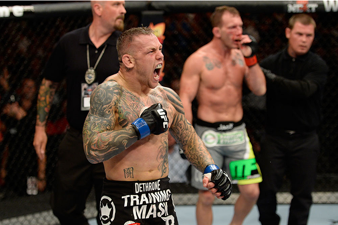BANGOR, ME - AUGUST 16:  (L-R) Ross Pearson celebrates after knocking out Gray Maynard in their lightweight bout during the UFC fight night event at the Cross Insurance Center on August 16, 2014 in Bangor, Maine. (Photo by Jeff Bottari/Zuffa LLC/Zuffa LLC via Getty Images)