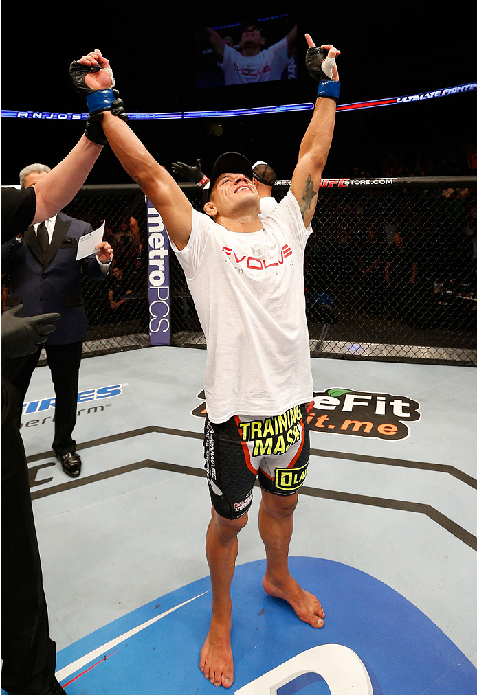 TULSA, OK - AUGUST 23:  Rafael dos Anjos of Brazil celebrates after his knockout victory over Benson Henderson in their lightweight fight during the UFC Fight Night event at the BOK Center on August 23, 2014 in Tulsa, Oklahoma. (Photo by Josh Hedges/Zuffa LLC/Zuffa LLC via Getty Images)