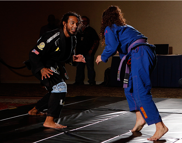 Benson Henderson grapples with his wife Maria at open workouts