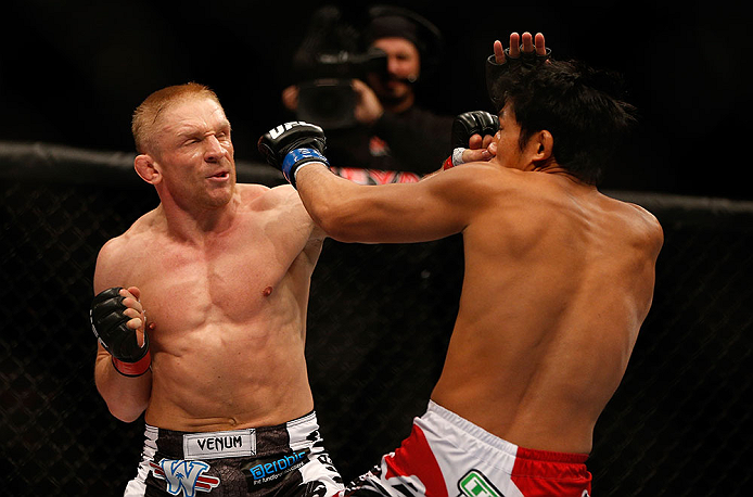 SEATTLE, WA - DECEMBER 08: (L-R) Dennis Siver punches Nam Phan during their featherweight bout at the UFC on FOX event on December 8, 2012 at Key Arena in Seattle, Washington. (Photo by Josh Hedges/Zuffa LLC/Zuffa LLC via Getty Images) *** Local Caption *** Dennis Siver; Nam Phan