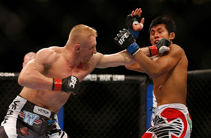 SEATTLE, WA - DECEMBER 08: (L-R) Dennis Siver punches Nam Phan during their featherweight bout at the UFC on FOX event on December 8, 2012 at Key Arena in Seattle, Washington. (Photo by Josh Hedges/Zuffa LLC/Zuffa LLC via Getty Images) *** Local Caption *** Dennis Siver; Nam Phan