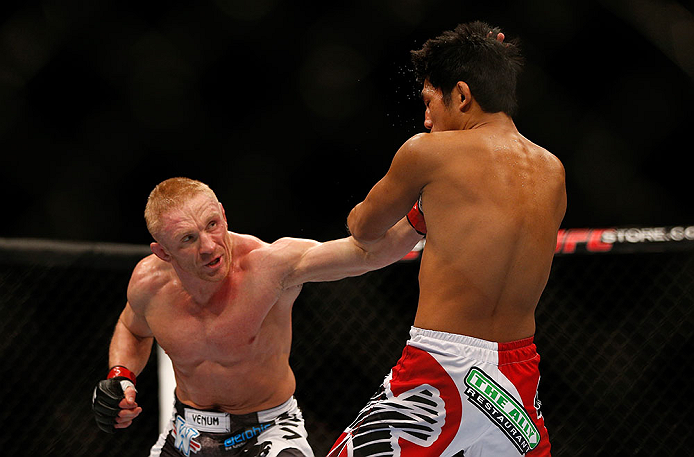 SEATTLE, WA - DECEMBER 08: (L-R) Dennis Siver punches Nam Phan during their featherweight bout at the UFC on FOX event on December 8, 2012 at Key Arena in Seattle, Washington. (Photo by Josh Hedges/Zuffa LLC/Zuffa LLC via Getty Images) *** Local Caption *** Dennis Siver; Nam Phan