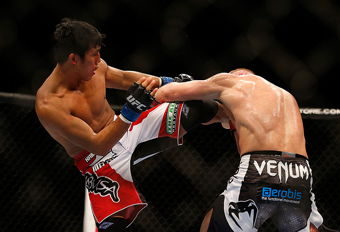 SEATTLE, WA - DECEMBER 08: (L-R) Nam Phan kicks Dennis Siverduring their featherweight bout at the UFC on FOX event on December 8, 2012 at Key Arena in Seattle, Washington. (Photo by Josh Hedges/Zuffa LLC/Zuffa LLC via Getty Images) *** Local Caption *** Dennis Siver; Nam Phan