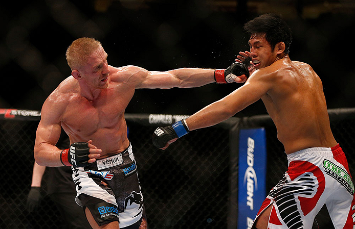 SEATTLE, WA - DECEMBER 08: (L-R) Dennis Siver punches Nam Phan during their featherweight bout at the UFC on FOX event on December 8, 2012 at Key Arena in Seattle, Washington. (Photo by Josh Hedges/Zuffa LLC/Zuffa LLC via Getty Images) *** Local Caption *** Dennis Siver; Nam Phan