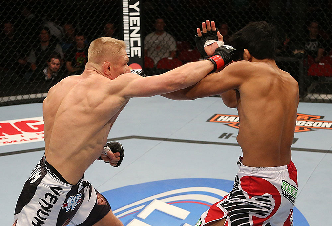 SEATTLE, WA - DECEMBER 08: (L-R) Dennis Siver punches Nam Phan during their featherweight bout at the UFC on FOX event on December 8, 2012 at Key Arena in Seattle, Washington. (Photo by Ezra Shaw/Zuffa LLC/Zuffa LLC via Getty Images) *** Local Caption *** Dennis Siver; Nam Phan