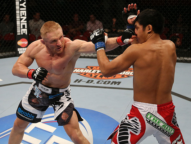 SEATTLE, WA - DECEMBER 08: (L-R) Dennis Siver punches Nam Phan during their featherweight bout at the UFC on FOX event on December 8, 2012 at Key Arena in Seattle, Washington. (Photo by Ezra Shaw/Zuffa LLC/Zuffa LLC via Getty Images) *** Local Caption *** Dennis Siver; Nam Phan