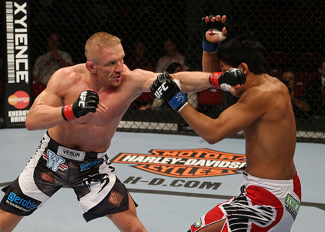 (L-R) Dennis Siver punches <a href='../fighter/Nam-Phan'>Nam Phan</a> during their featherweight bout at the UFC on FOX event on December 8, 2012 at Key Arena in Seattle, Washington. (Photo by Ezra Shaw/Zuffa LLC)
