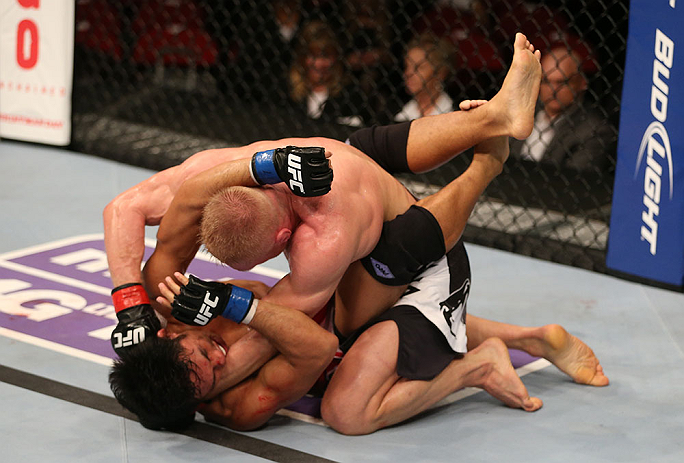 SEATTLE, WA - DECEMBER 08: Dennis Siver (top) punches Nam Phan (bottom)during their featherweight bout at the UFC on FOX event on December 8, 2012 at Key Arena in Seattle, Washington. (Photo by Ezra Shaw/Zuffa LLC/Zuffa LLC via Getty Images) *** Local Caption *** Dennis Siver; Nam Phan