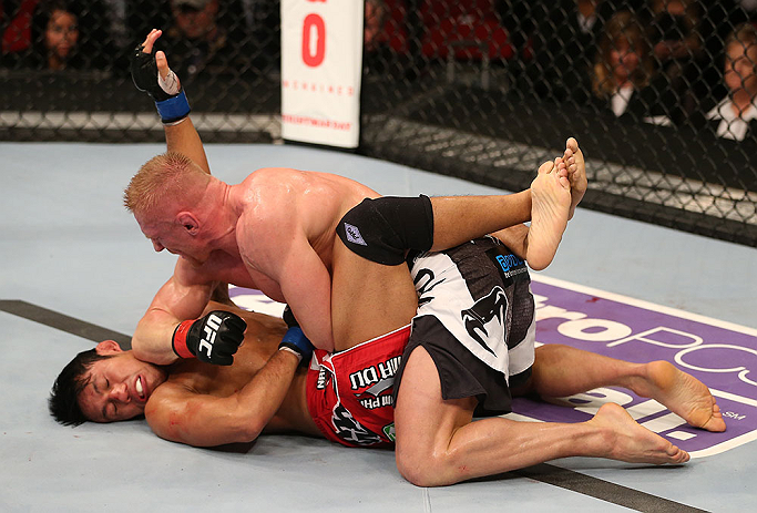 SEATTLE, WA - DECEMBER 08: Dennis Siver (top) elbows Nam Phan (bottom)during their featherweight bout at the UFC on FOX event on December 8, 2012 at Key Arena in Seattle, Washington. (Photo by Ezra Shaw/Zuffa LLC/Zuffa LLC via Getty Images) *** Local Caption *** Dennis Siver; Nam Phan