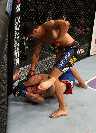 SEATTLE, WA - DECEMBER 08: Ramsey Nijem (top) punches Joe Proctor (bottom) during their lightweight bout at the UFC on FOX event on December 8, 2012 at Key Arena in Seattle, Washington. (Photo by Ezra Shaw/Zuffa LLC/Zuffa LLC via Getty Images) *** Local Caption *** Ramsey Nijem; Joe Proctor