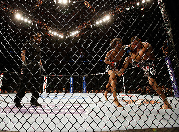 SEATTLE, WA - DECEMBER 08: Referee Herb Dean (left) looks on at Benson Henderson punches Nate Diaz during their lightweight championship bout at the UFC on FOX event on December 8, 2012 at Key Arena in Seattle, Washington. (Photo by Josh Hedges/Zuffa LLC/Zuffa LLC via Getty Images) *** Local Caption *** Benson Henderson; Nate Diaz