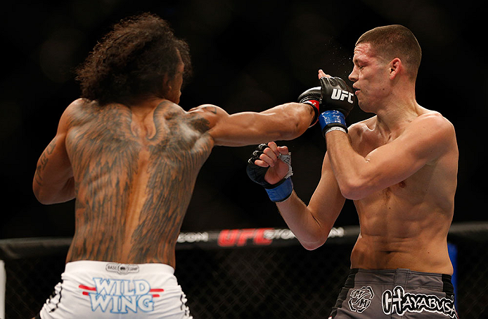 SEATTLE, WA - DECEMBER 08: Benson Henderson (L) punches Nate Diaz (R) during their lightweight championship bout at the UFC on FOX event on December 8, 2012 at Key Arena in Seattle, Washington. (Photo by Josh Hedges/Zuffa LLC/Zuffa LLC via Getty Images) *** Local Caption *** Benson Henderson; Nate Diaz