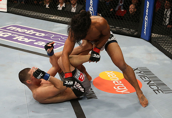 SEATTLE, WA - DECEMBER 08: (R-L) Benson Henderson punches Nate Diaz during their lightweight championship bout at the UFC on FOX event on December 8, 2012 at Key Arena in Seattle, Washington. (Photo by Ezra Shaw/Zuffa LLC/Zuffa LLC via Getty Images) *** Local Caption *** Benson Henderson; Nate Diaz