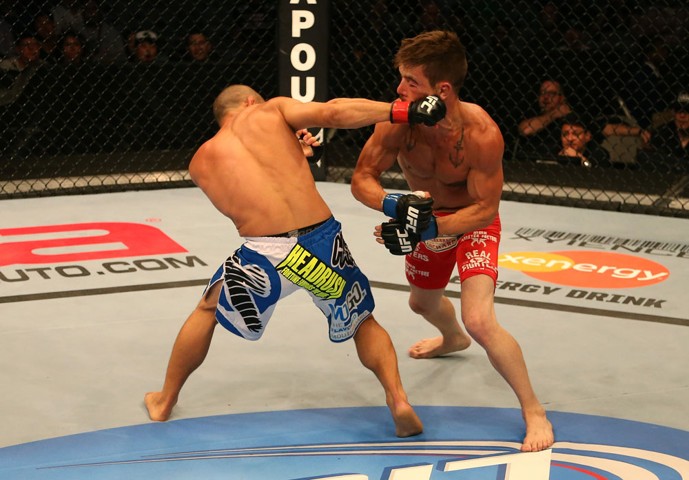 SAN JOSE, CA - JULY 11: (L-R) Chris Cariaso punches Josh Ferguson during their flyweight bout at HP Pavilion on July 11, 2012 in San Jose, California. (Photo by Ezra Shaw/Zuffa LLC/Zuffa LLC via Getty Images) *** Local Caption *** Chris Cariaso; Josh Ferguson