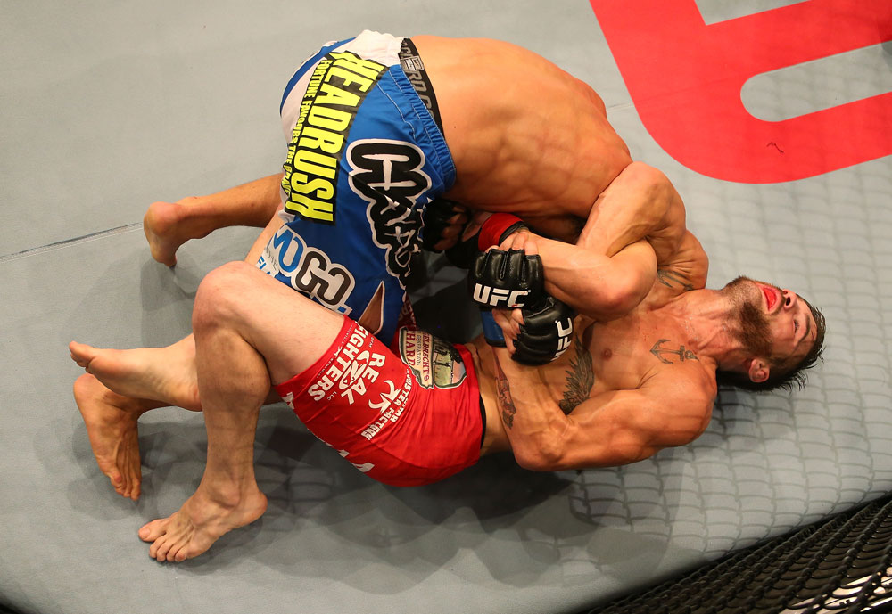 SAN JOSE, CA - JULY 11: Josh Ferguson (red shorts) attempts to submit Chris Cariaso during their flyweight bout at HP Pavilion on July 11, 2012 in San Jose, California. (Photo by Ezra Shaw/Zuffa LLC/Zuffa LLC via Getty Images) *** Local Caption *** Chris Cariaso; Josh Ferguson