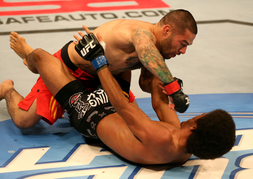 SAN JOSE, CA - JULY 11: Damacio Page (top) punches Alex Caceres during their bantamweight bout at HP Pavilion on July 11, 2012 in San Jose, California. (Photo by Ezra Shaw/Zuffa LLC/Zuffa LLC via Getty Images) *** Local Caption *** Damacio Page; Alex Caceres