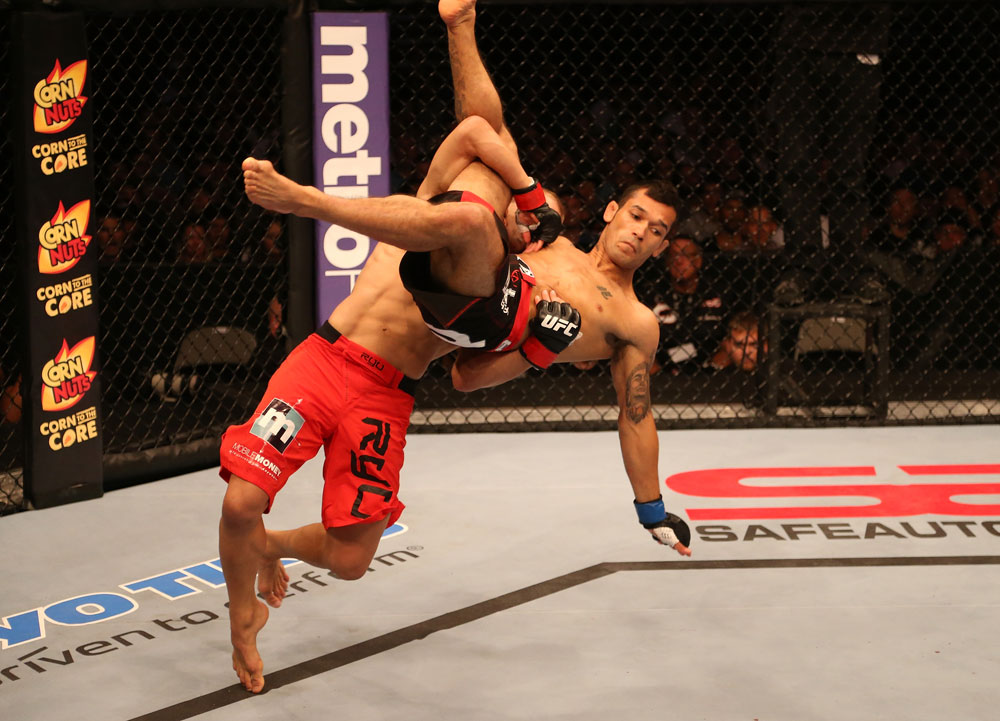 SAN JOSE, CA - JULY 11: TJ Dillashaw (red shorts) lifts Vaughan Lee into the air during their bantamweight bout at HP Pavilion on July 11, 2012 in San Jose, California. (Photo by Ezra Shaw/Zuffa LLC/Zuffa LLC via Getty Images) *** Local Caption *** T.J. Dillashaw; Vaughn Lee
