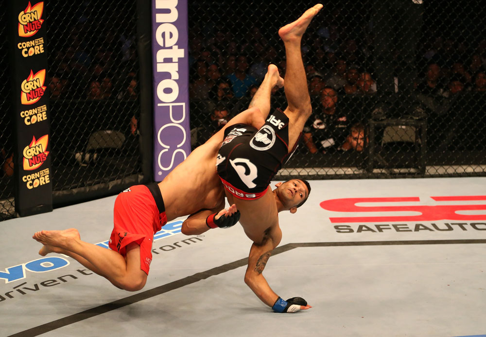 SAN JOSE, CA - JULY 11: TJ Dillashaw (red shorts) slams Vaughan Lee during their bantamweight bout at HP Pavilion on July 11, 2012 in San Jose, California. (Photo by Ezra Shaw/Zuffa LLC/Zuffa LLC via Getty Images) *** Local Caption *** T.J. Dillashaw; Vaughn Lee