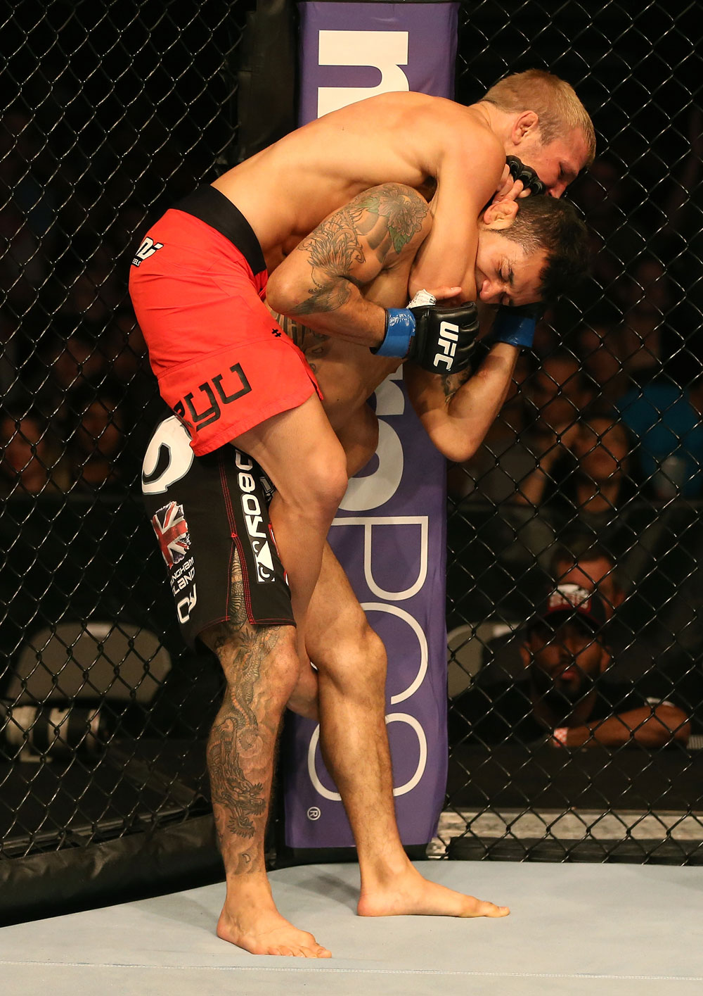 SAN JOSE, CA - JULY 11: TJ Dillashaw (red shorts) attempts to submit Vaughan Lee during their bantamweight bout at HP Pavilion on July 11, 2012 in San Jose, California. (Photo by Ezra Shaw/Zuffa LLC/Zuffa LLC via Getty Images) *** Local Caption *** T.J. Dillashaw; Vaughn Lee