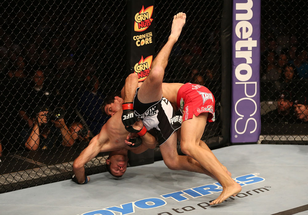 SAN JOSE, CA - JULY 11: Aaron Simpson (red shorts) slams Kenny Robertson during their welterweight bout at HP Pavilion on July 11, 2012 in San Jose, California. (Photo by Ezra Shaw/Zuffa LLC/Zuffa LLC via Getty Images) *** Local Caption *** Aaron Simpson; Kenny Robertson