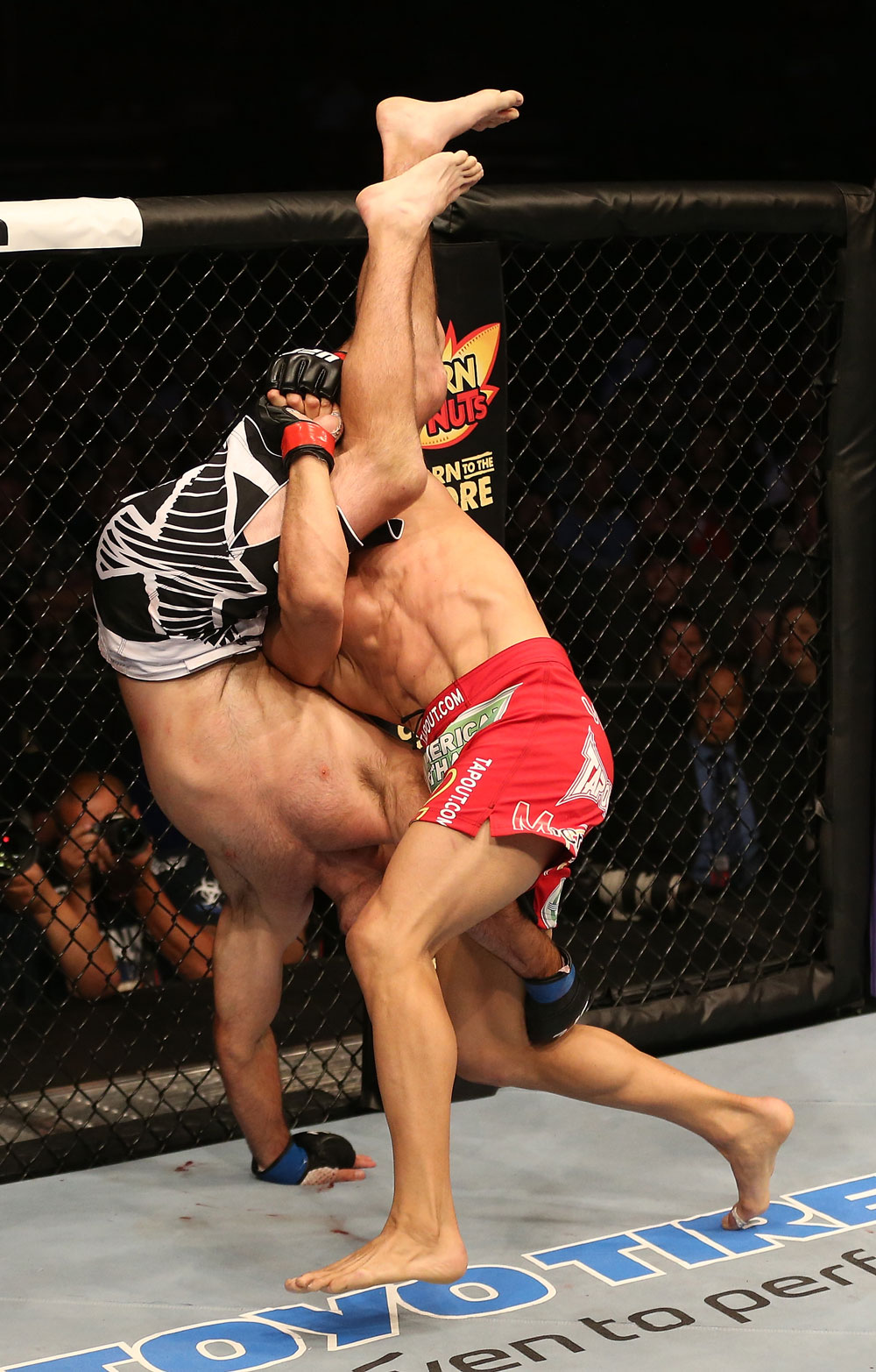 SAN JOSE, CA - JULY 11: Aaron Simpson (red shorts) slams Kenny Robertson during their welterweight bout at HP Pavilion on July 11, 2012 in San Jose, California. (Photo by Ezra Shaw/Zuffa LLC/Zuffa LLC via Getty Images) *** Local Caption *** Aaron Simpson; Kenny Robertson