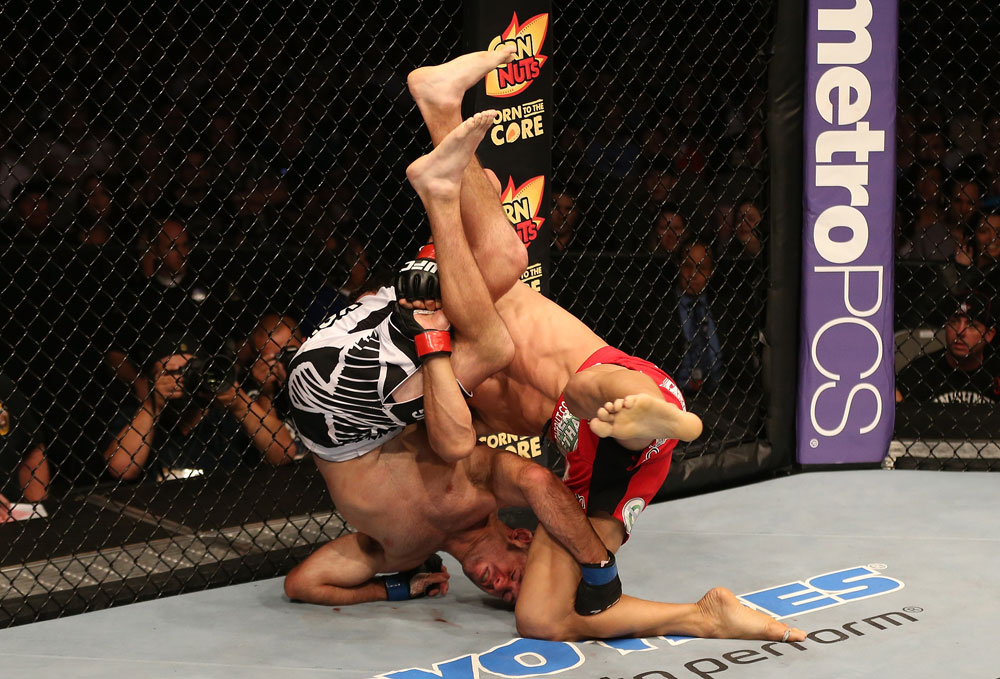 SAN JOSE, CA - JULY 11: Aaron Simpson (red shorts) slams Kenny Robertson during their welterweight bout at HP Pavilion on July 11, 2012 in San Jose, California. (Photo by Ezra Shaw/Zuffa LLC/Zuffa LLC via Getty Images) *** Local Caption *** Aaron Simpson; Kenny Robertson