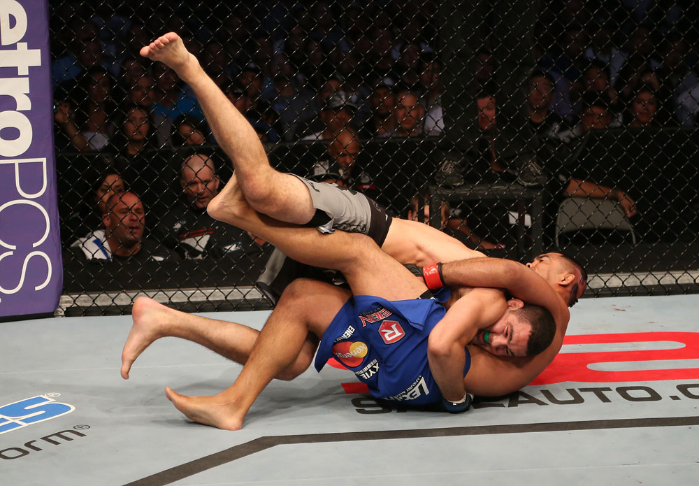 SAN JOSE, CA - JULY 11: Chris Weidman (grey shorts) takes down Mark Munoz during their middleweight bout at HP Pavilion on July 11, 2012 in San Jose, California. (Photo by Ezra Shaw/Zuffa LLC/Zuffa LLC via Getty Images) *** Local Caption *** Mark Munoz; Chris Weidman