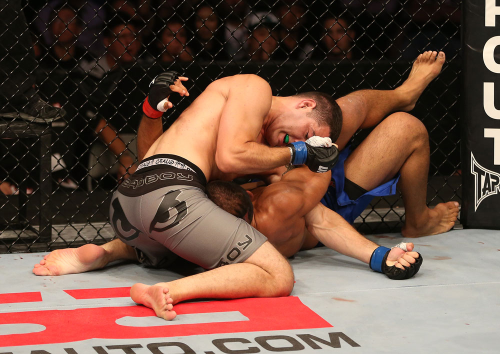 SAN JOSE, CA - JULY 11: Chris Weidman (grey shorts) elbows Mark Munoz during their middleweight bout at HP Pavilion on July 11, 2012 in San Jose, California. (Photo by Ezra Shaw/Zuffa LLC/Zuffa LLC via Getty Images) *** Local Caption *** Mark Munoz; Chris Weidman