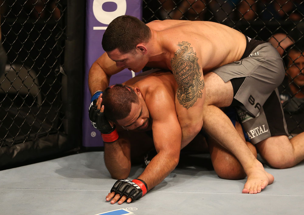 SAN JOSE, CA - JULY 11: Chris Weidman (grey shorts) punches Mark Munoz during their middleweight bout at HP Pavilion on July 11, 2012 in San Jose, California. (Photo by Ezra Shaw/Zuffa LLC/Zuffa LLC via Getty Images) *** Local Caption *** Mark Munoz; Chris Weidman