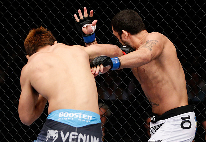 MACAU, MACAU - NOVEMBER 10: (L-R) Riki Fukuda punches Tom DeBlass during their middleweight bout at the UFC Macao event inside CotaiArena on November 10, 2012 in Macau, Macau. (Photo by Josh Hedges/Zuffa LLC/Zuffa LLC via Getty Images)
