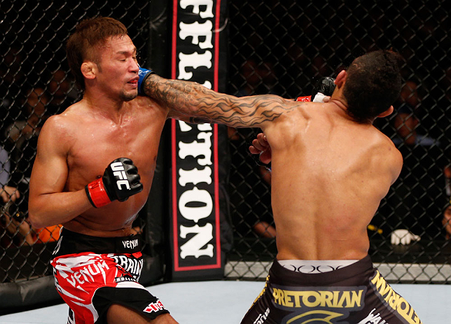 MACAU, MACAU - NOVEMBER 10:  (L-R) Yasuhiro Urushitani punches John Lineker during their flyweight bout at the UFC Macao event inside CotaiArena on November 10, 2012 in Macau, Macau.  (Photo by Josh Hedges/Zuffa LLC/Zuffa LLC via Getty Images)