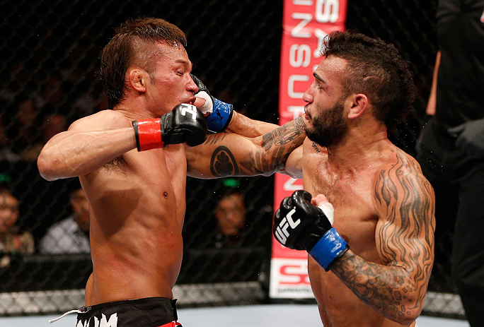 MACAU, MACAU - NOVEMBER 10:  (R-L) John Lineker and Yasuhiro Urushitani trade punches during their flyweight bout at the UFC Macao event inside CotaiArena on November 10, 2012 in Macau, Macau.  (Photo by Josh Hedges/Zuffa LLC/Zuffa LLC via Getty Images)