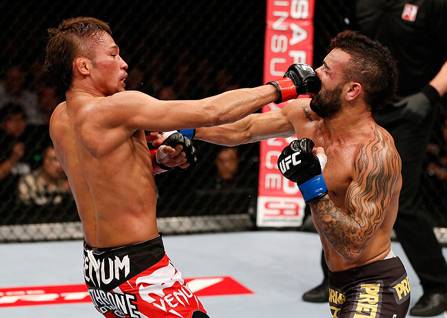 MACAU, MACAU - NOVEMBER 10:  (L-R) Yasuhiro Urushitani punches John Lineker during their flyweight bout at the UFC Macao event inside CotaiArena on November 10, 2012 in Macau, Macau.  (Photo by Josh Hedges/Zuffa LLC/Zuffa LLC via Getty Images)