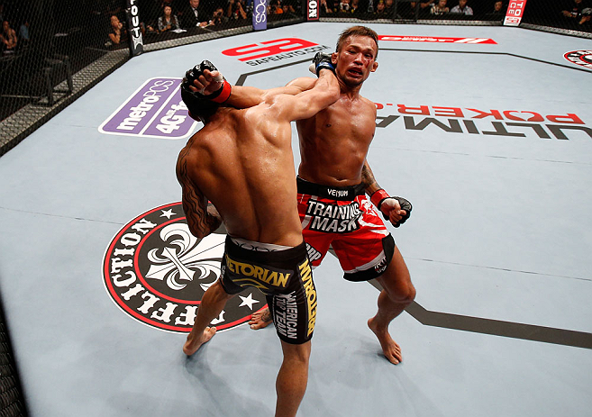 MACAU, MACAU - NOVEMBER 10: (L-R) John Lineker punches Yasuhiro Urushitani during their flyweight bout at the UFC Macao event inside CotaiArena on November 10, 2012 in Macau, Macau. (Photo by Josh Hedges/Zuffa LLC/Zuffa LLC via Getty Images)