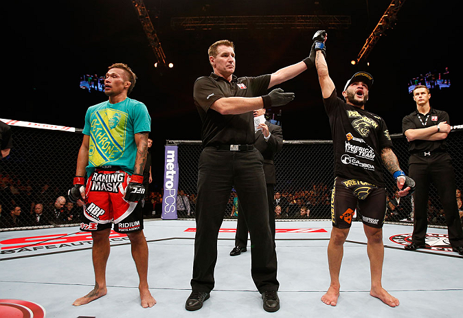 MACAU, MACAU - NOVEMBER 10: John Lineker (R) reacts after defeating Yasuhiro Urushitani (L) during their flyweight bout at the UFC Macao event inside CotaiArena on November 10, 2012 in Macau, Macau. (Photo by Josh Hedges/Zuffa LLC/Zuffa LLC via Getty Images)